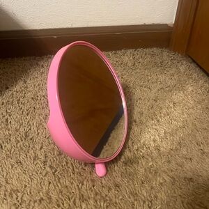 Pink mini mirror with small cubby/holder in the back